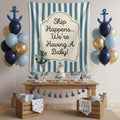 Nautical-themed baby shower party setup with a large blue and white striped banner reading 'Ship Happens we are having a baby