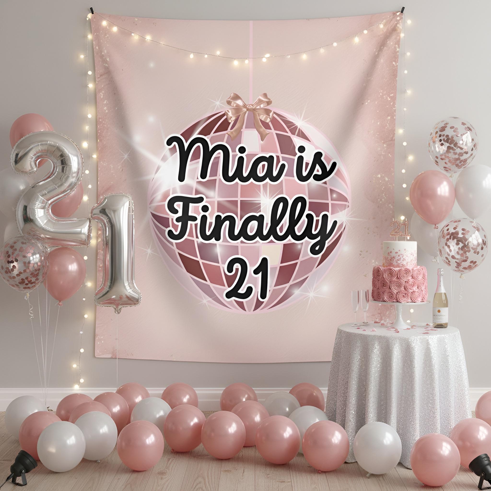 A pink 21st birthday party backdrop tapestry featuring a disco ball graphic and the text 'Finally 21', styled in a party room with pink and white balloons, silver '21' balloons, fairy lights, and a decorated cake table.