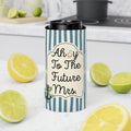 A slim can cooler sleeve with a black lid, featuring a blue and white striped pattern and the text 'Ahoy To The Future Mrs.' with a small anchor and floral design, set on a kitchen counter surrounded by lemons and limes.