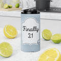 A light blue can cooler sleeve with a white label reading 'Finally 21' in black script, shown around a black can on a kitchen countertop with lemon and lime slices around it.