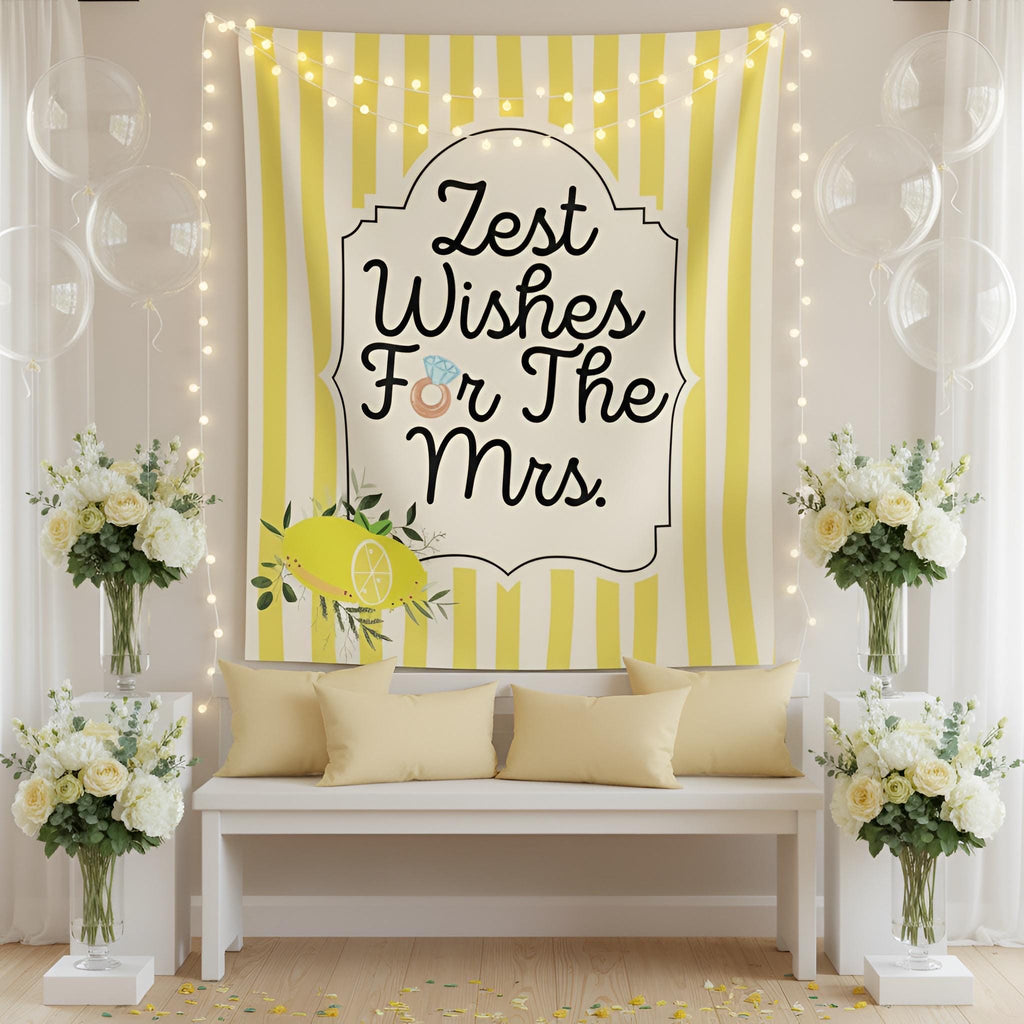 A yellow and white striped fabric wall tapestry with the text 'Zest Wishes For The Mrs.' in black script, styled in a festive room setting with a white bench, pillows, string lights, and floral arrangements.