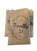 Three brown kraft paper party favor bags on a white background, with the center bag printed in black script reading 'Finally 21'.