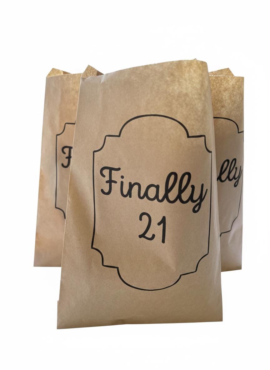 Three brown kraft paper party favor bags on a white background, with the center bag printed in black script reading 'Finally 21'.