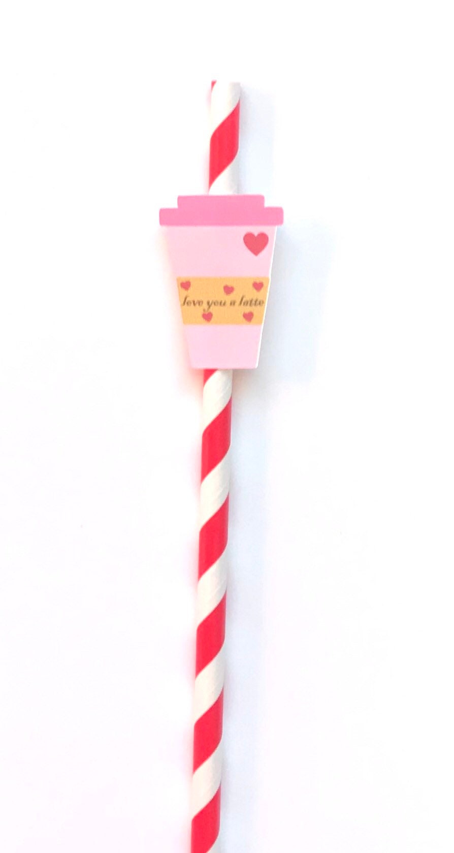 A red and white striped paper straw with a pink paper cup charm featuring a small heart and the text 'love you a latte’ in gold script, shown on a plain white background.