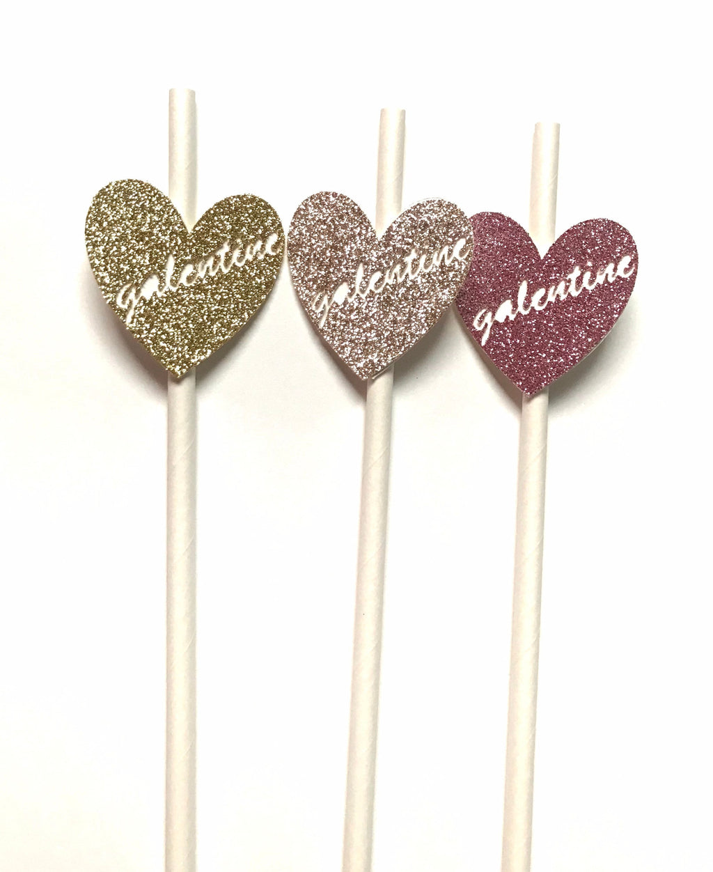 Three heart-shaped glitter topper picks on white sticks, featuring the word 'galentine' in white script, shown against a plain white background.