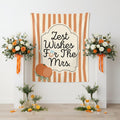 A vertical fabric banner with orange and cream vertical stripes, featuring a central cream arch with the text 'Zest Wishes For The Mrs.' in black script.